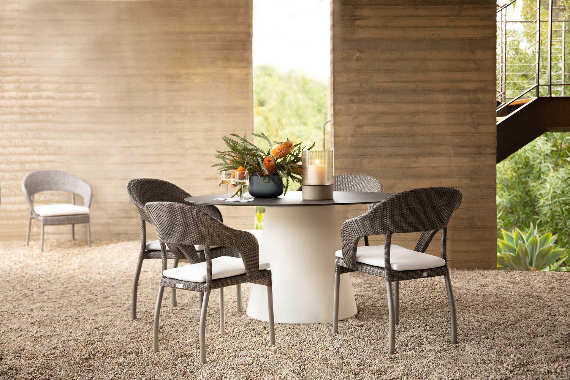 Table ronde dessus en corian noir et base cylindrique conique blanche du fabricant Janus et Cie