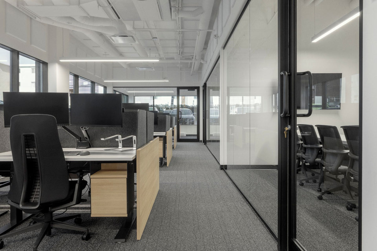 Aménagement de bureau moderne à aire ouverte avec postes de travail ergonomiques, salles de réunion vitrées et mobilier professionnel haut de gamme. Solution complète incluant bureaux ajustables en bois clair, chaises ergonomiques et cloisons acoustiques pour maximiser la productivité de votre entreprise.